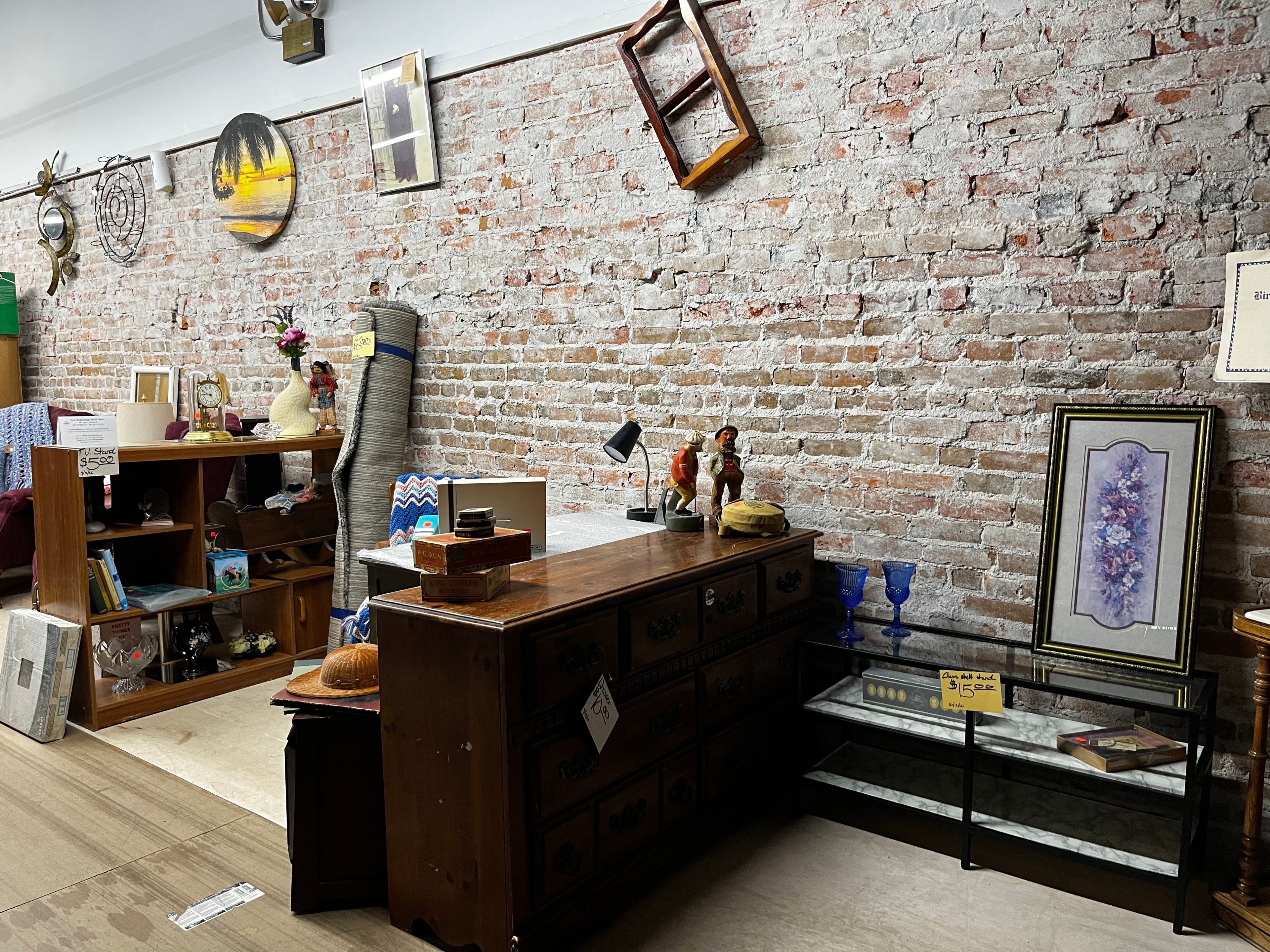 First floor vintage furniture and home decor against exposed brick wall